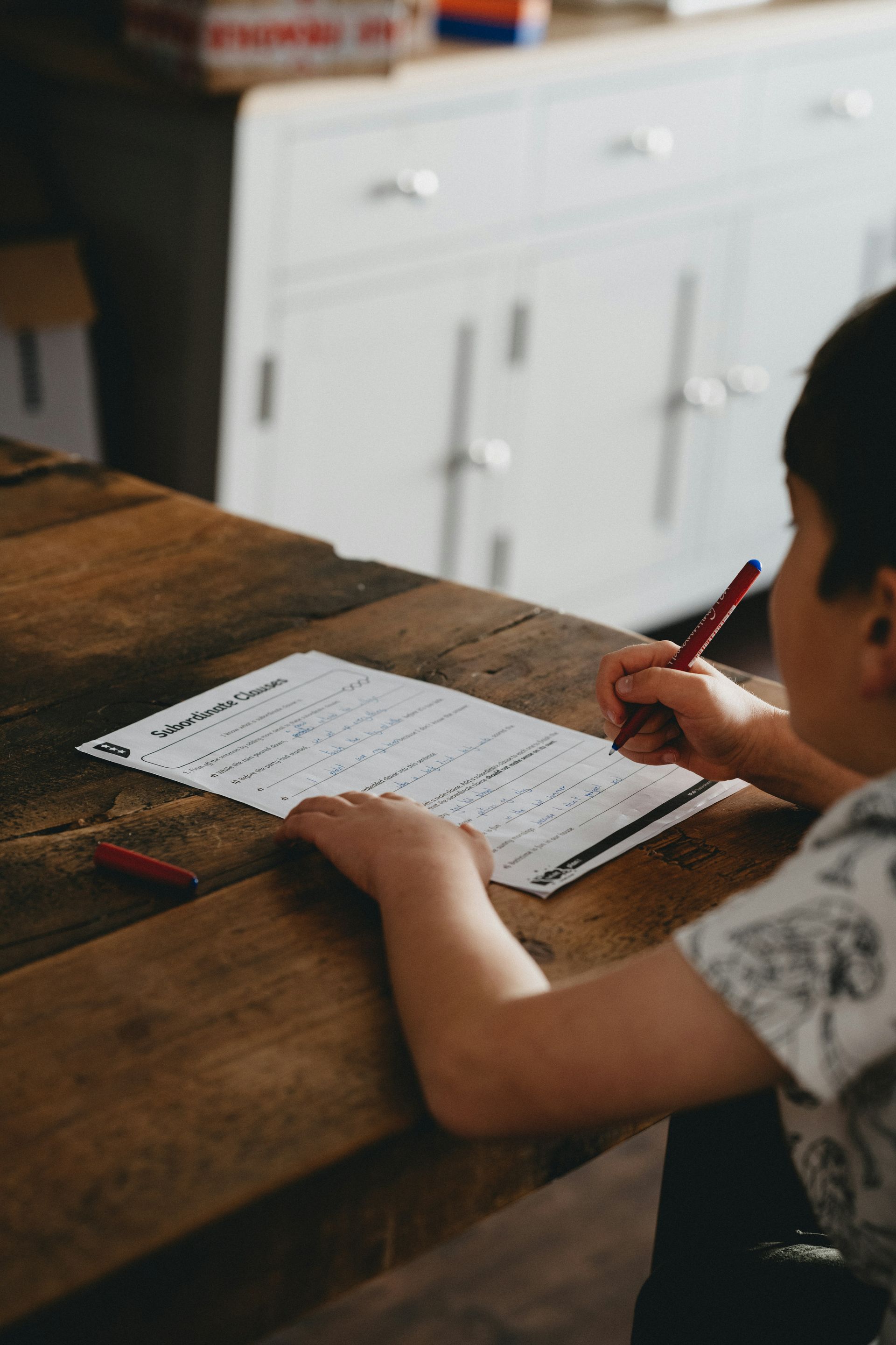 person writing on white paper